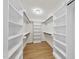 Spacious walk-in closet with ample shelving and hanging rods at 154 Leatherwood Ln, Chapel Hill, NC 27517