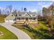 Two-story craftsman style home with a large front porch and three car garage at 154 Leatherwood Ln, Chapel Hill, NC 27517