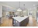 Open concept kitchen with large island, and views into the dining and living areas at 154 Leatherwood Ln, Chapel Hill, NC 27517