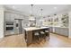 Modern kitchen with island, stainless steel appliances, and lots of natural light at 154 Leatherwood Ln, Chapel Hill, NC 27517
