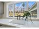 Modern kitchen sink with a white farmhouse sink, stainless steel faucet, and a view of the backyard at 154 Leatherwood Ln, Chapel Hill, NC 27517
