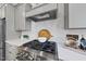 Stainless steel gas cooktop with gray shaker cabinets and white quartz countertops at 154 Leatherwood Ln, Chapel Hill, NC 27517
