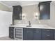 Modern wet bar with dark cabinetry and quartz countertops at 154 Leatherwood Ln, Chapel Hill, NC 27517