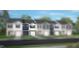 Two-story townhome with gray siding, white trim, and a two-car garage at 19 Sweet Meadow Rd, Angier, NC 27501