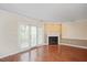 Living room with hardwood floors, fireplace, and access to patio at 3116 Coachmans Way, Durham, NC 27705