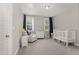 Charming Bedroom featuring a crib, armchair, and dresser at 323 W Amber Oak Dr, Selma, NC 27576