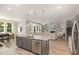 Modern kitchen with island, stainless steel appliances, and white cabinets at 323 W Amber Oak Dr, Selma, NC 27576