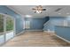 Open living area with hardwood floors and access to the kitchen and stairs at 638 Whitetail Creek Way, Fuquay Varina, NC 27526