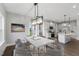 Dining room with large windows and modern light fixture at 8749 Maxine St # 11 Holly, Willow Springs, NC 27592