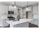 Modern kitchen with white cabinets, island, and quartz countertops at 8749 Maxine St # 11 Holly, Willow Springs, NC 27592
