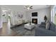 Living room featuring fireplace, hardwood floors, and comfortable seating at 8749 Maxine St # 11 Holly, Willow Springs, NC 27592