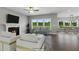 Spacious living room with fireplace, hardwood floors, and access to dining area at 8749 Maxine St # 11 Holly, Willow Springs, NC 27592