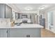 Open kitchen with stainless steel appliances, a white countertop, and gray cabinetry at 1008 Mingo Pl, Knightdale, NC 27545