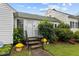Inviting front entrance with stairs and potted plants at 1146 Rogers Rd, Graham, NC 27253
