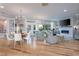 Open concept dining area with a round table and white chairs at 1208 Restoration Dr, Durham, NC 27703