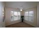 Bright bedroom featuring two windows and ceiling fan at 2410 Huntscroft Ln # 203, Raleigh, NC 27617