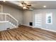 Bright living room with hardwood floors, built-in shelving and ceiling fan at 3009 E Garner Rd, Raleigh, NC 27610