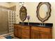Bathroom with double vanity, granite countertop, and glass block shower at 318 Rawls Church Rd, Angier, NC 27501