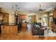 Open kitchen with island, stainless steel appliances, and hardwood floors at 318 Rawls Church Rd, Angier, NC 27501