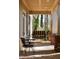 Relaxing covered porch with swing and bistro set at 318 Rawls Church Rd, Angier, NC 27501
