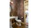 Elegant powder room with unique wallpaper and a pedestal sink at 318 Rawls Church Rd, Angier, NC 27501