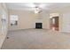 Living room with fireplace, neutral carpeting and view into dining area at 3226 Enchanting Way Way, Raleigh, NC 27616