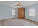 Light blue bedroom with a wooden closet and windows at 345 Henderson St, Oxford, NC 27565