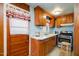 Small kitchen with wood cabinets and appliances at 511 Elmira Ave, Durham, NC 27707