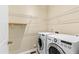 Bright laundry room features washer, dryer, and ample shelving at 809 Davidson Point Rd, Cary, NC 27513