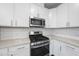 Modern kitchen with stainless steel appliances and white cabinetry at 1005 Kindness Ln, Durham, NC 27703