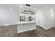 Modern kitchen with white cabinets, quartz countertops and island at 1005 Kindness Ln, Durham, NC 27703