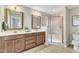 Double vanity bathroom with a large shower and neutral tones at 1032 Urbane Ct, Durham, NC 27713