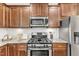 Modern kitchen features stainless steel appliances and granite countertops at 1032 Urbane Ct, Durham, NC 27713