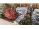 Aerial view of a two-story house with a driveway and vibrant tree at 105 Reton Ct, Cary, NC 27513