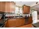 Kitchen with dark wood cabinets, granite counters, and stainless steel appliances at 128 Chownings Dr, Sanford, NC 27330