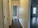 Hallway with hardwood floors and doors to other rooms at 15 Madinah Ct, Youngsville, NC 27596