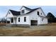 Two-story farmhouse with white siding, stone accents, and a two-car garage at 1590 Nc 96 Hwy S, Franklinton, NC 27525