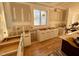 Unfinished kitchen with white cabinets and hardwood floors at 168 Daphine Dr, Hillsborough, NC 27278