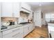 Modern kitchen with gas cooktop and granite countertops at 200 Holbrook Hill Ln, Holly Springs, NC 27540