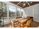 Relaxing screened porch with wooden table and chairs at 200 Holbrook Hill Ln, Holly Springs, NC 27540