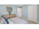 Light blue bedroom with a dresser and a door at 2010 Fletchers Ridge Dr, Durham, NC 27703