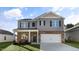 Two-story house with gray siding, brick accents, and a two-car garage at 2010 Fletchers Ridge Dr, Durham, NC 27703