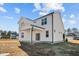 Two-story home with covered patio and grassy yard at 22 Laramie Ln, Selma, NC 27576