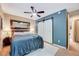 Main bedroom with king bed, barn doors to closet, and ceiling fan at 2216 Lawrence Dr, Raleigh, NC 27603