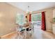 Dining area with a wooden table, white chairs, and access to deck at 2216 Lawrence Dr, Raleigh, NC 27603