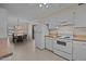 Eat-in kitchen with white appliances and adjacent dining area at 2942 Woodside Ave, Graham, NC 27253