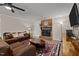 Living room featuring a brick fireplace, comfortable seating, and a large TV at 2942 Woodside Ave, Graham, NC 27253