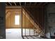 Unfinished bonus room with sloped ceilings and window at 30 Basil Ct, Franklinton, NC 27525