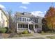 Two-story home with gray siding, stone accents, and a wrap-around porch at 3012 Bear Oak Ln, Cary, NC 27519