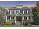 Two-story home with gray siding, stone accents, and a wrap-around porch at 3012 Bear Oak Ln, Cary, NC 27519